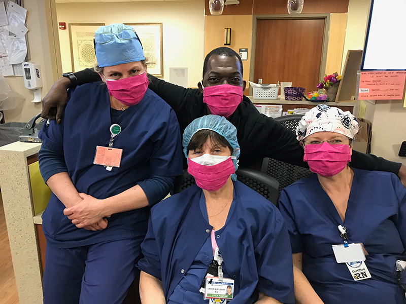 Hospital staff wearing handmade masks and scrub caps
